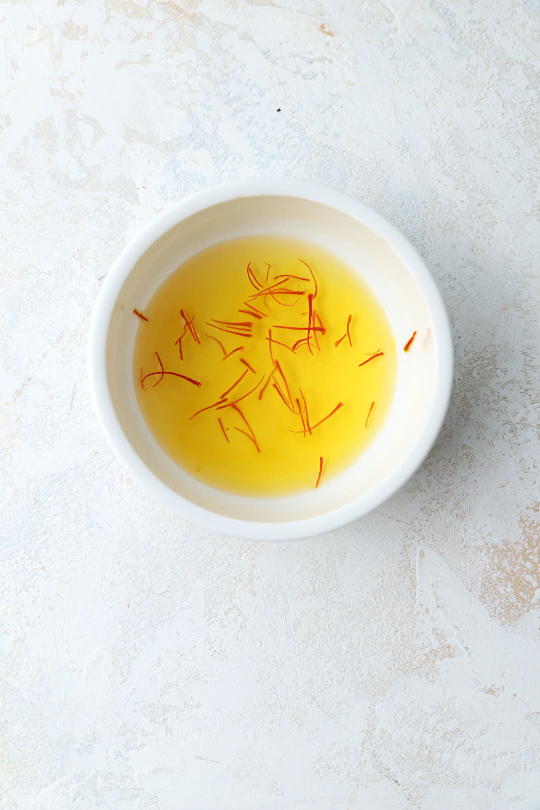 saffron steeped in warm water in small bowl.