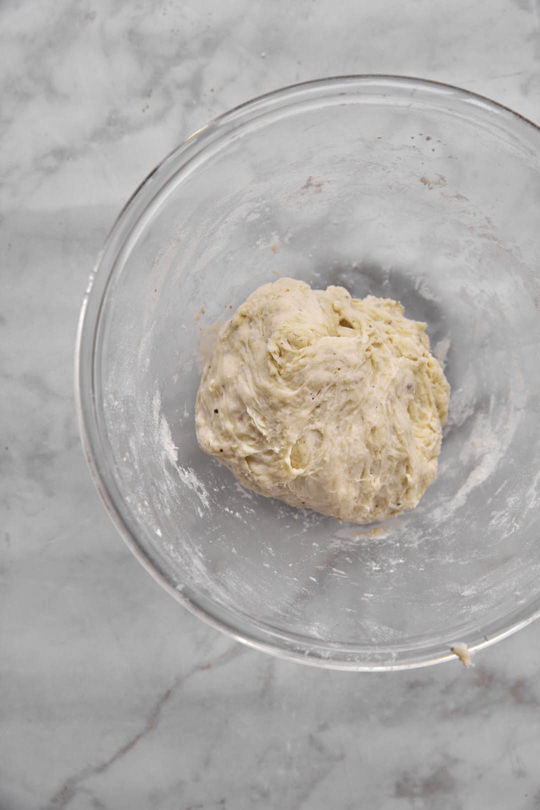 pizza dough ball in glass bowl.