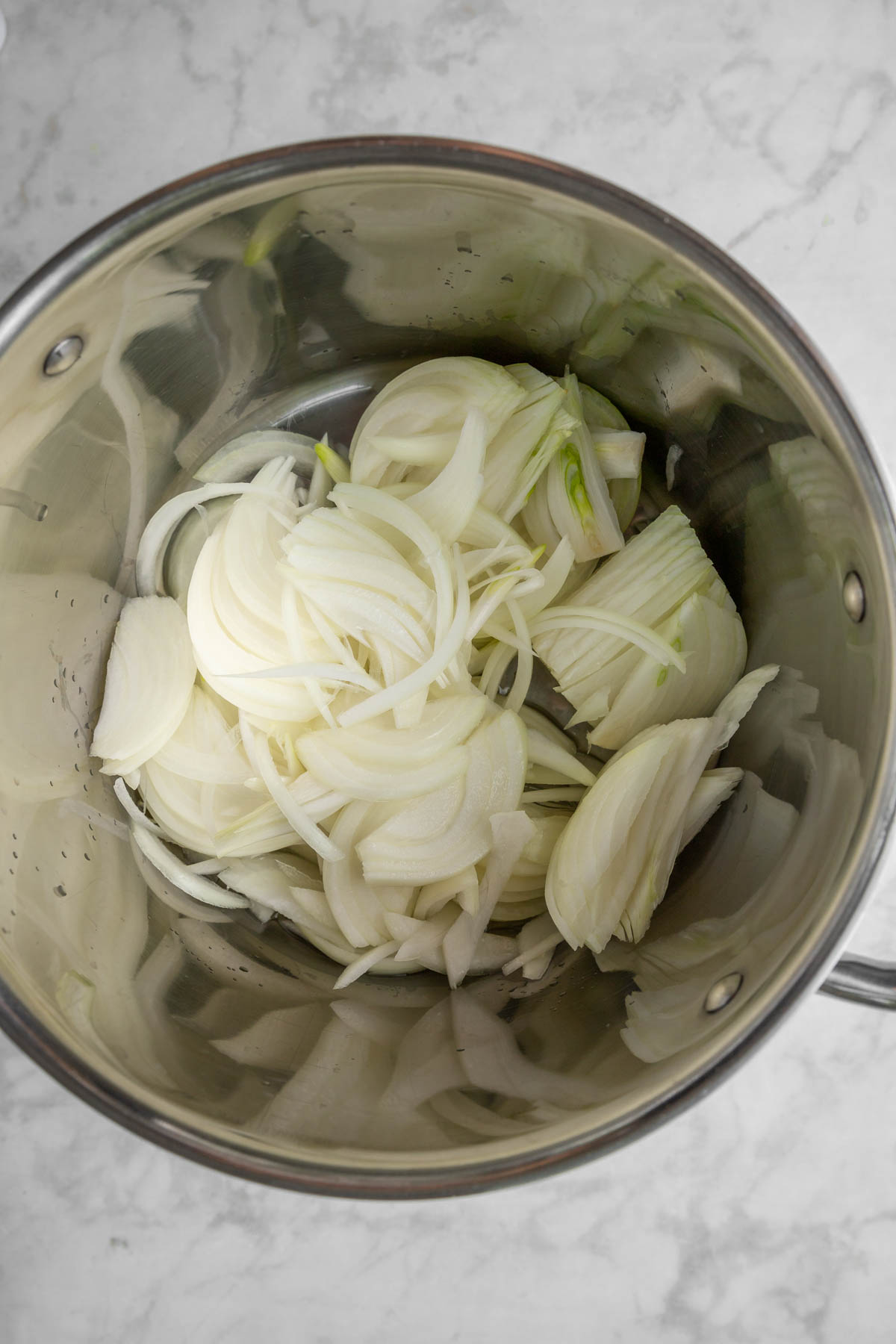 Onions in a saucepan before cooking.