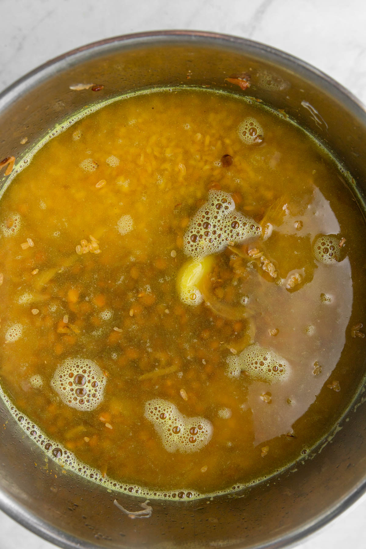 Lentils and bulgur in saucepan with water.