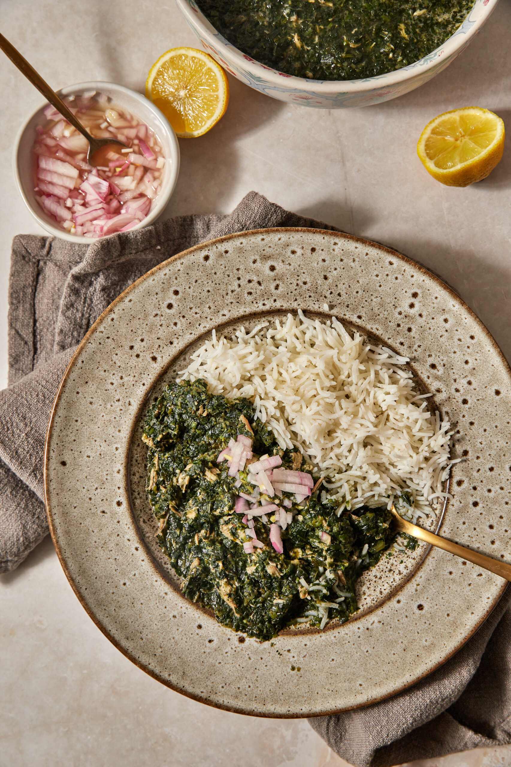 mulukhiyah with some pickled red onions on the side.