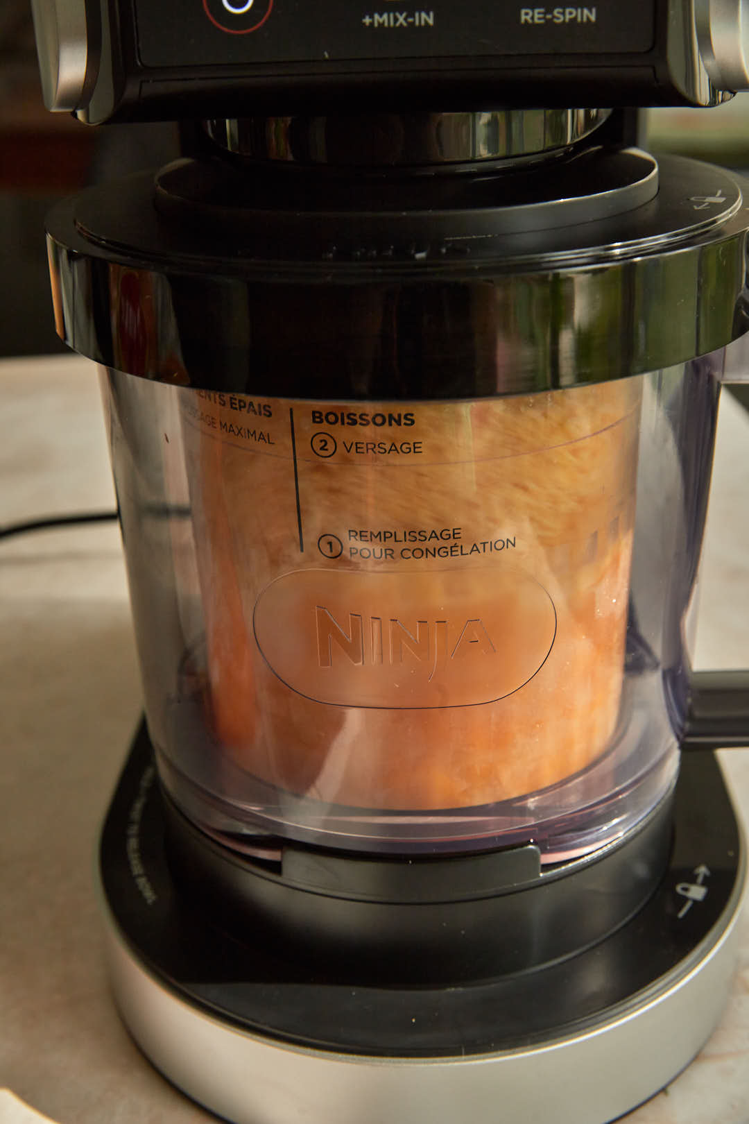 ninja creami mango sorbet in the creami machine.