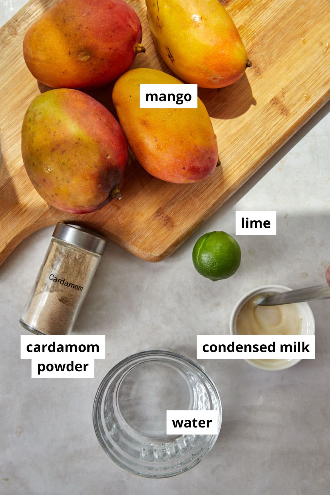 ingredients needed for ninja creami mango sorbet on a chopping board.