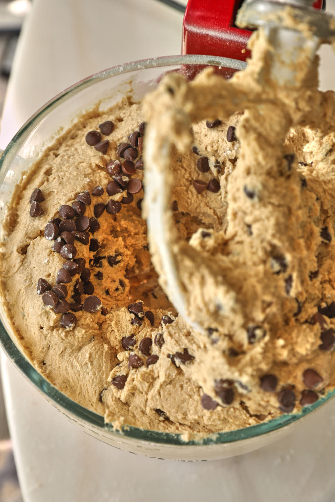 chocolate chips added to cookie dough in stand mixer.