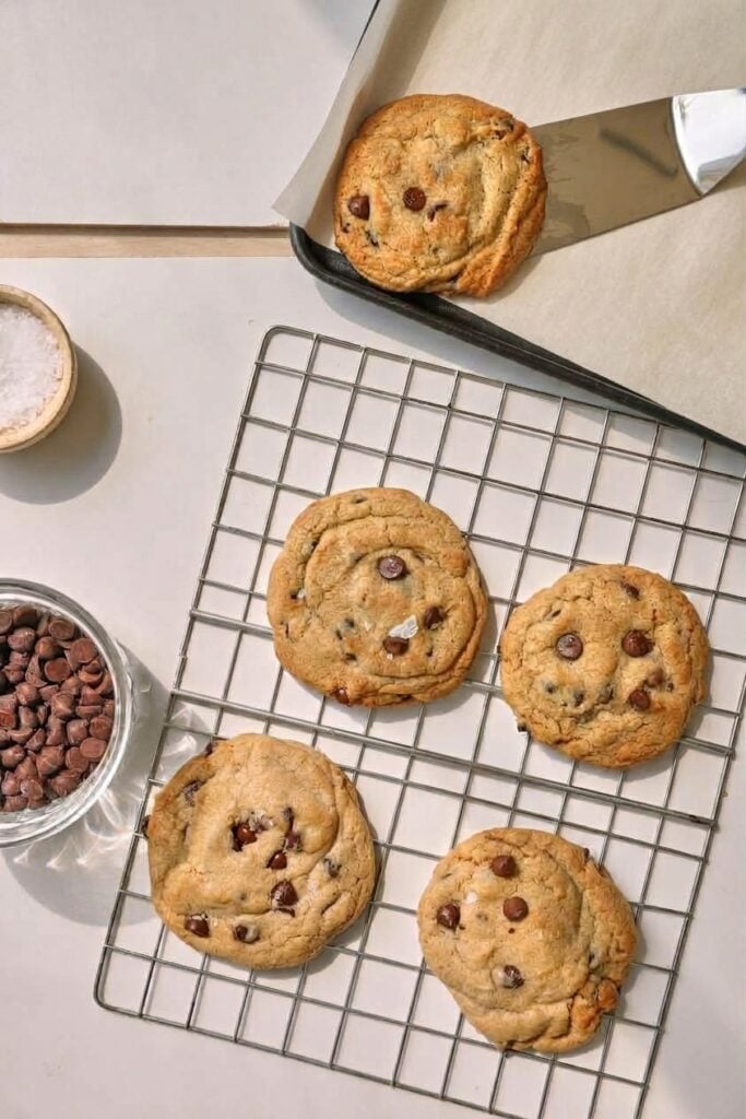 chocolate chip cookies cooling on a wire rack on a white background.