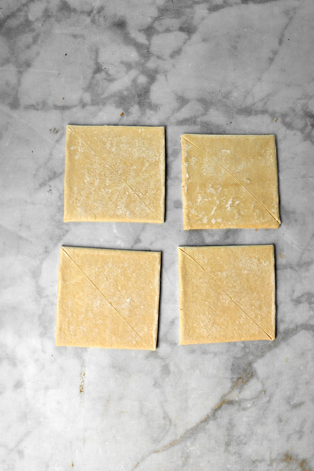 puff pastry squares on marble background.