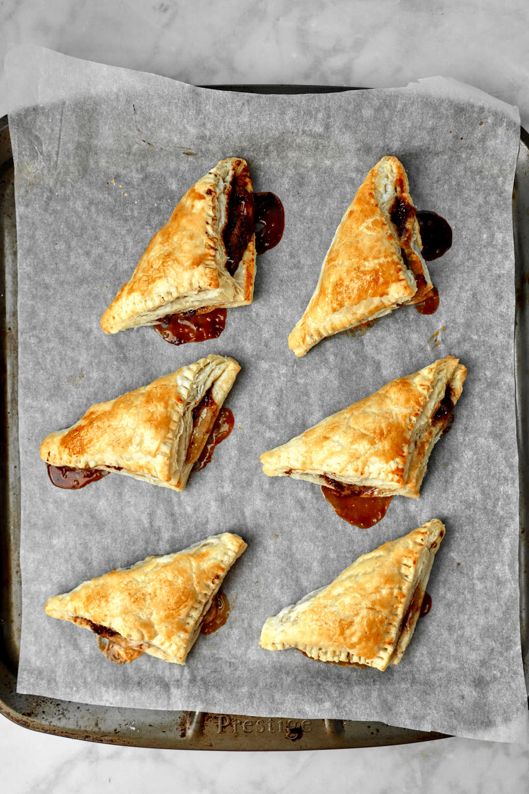 Nutella turnovers after baking on baking sheet.