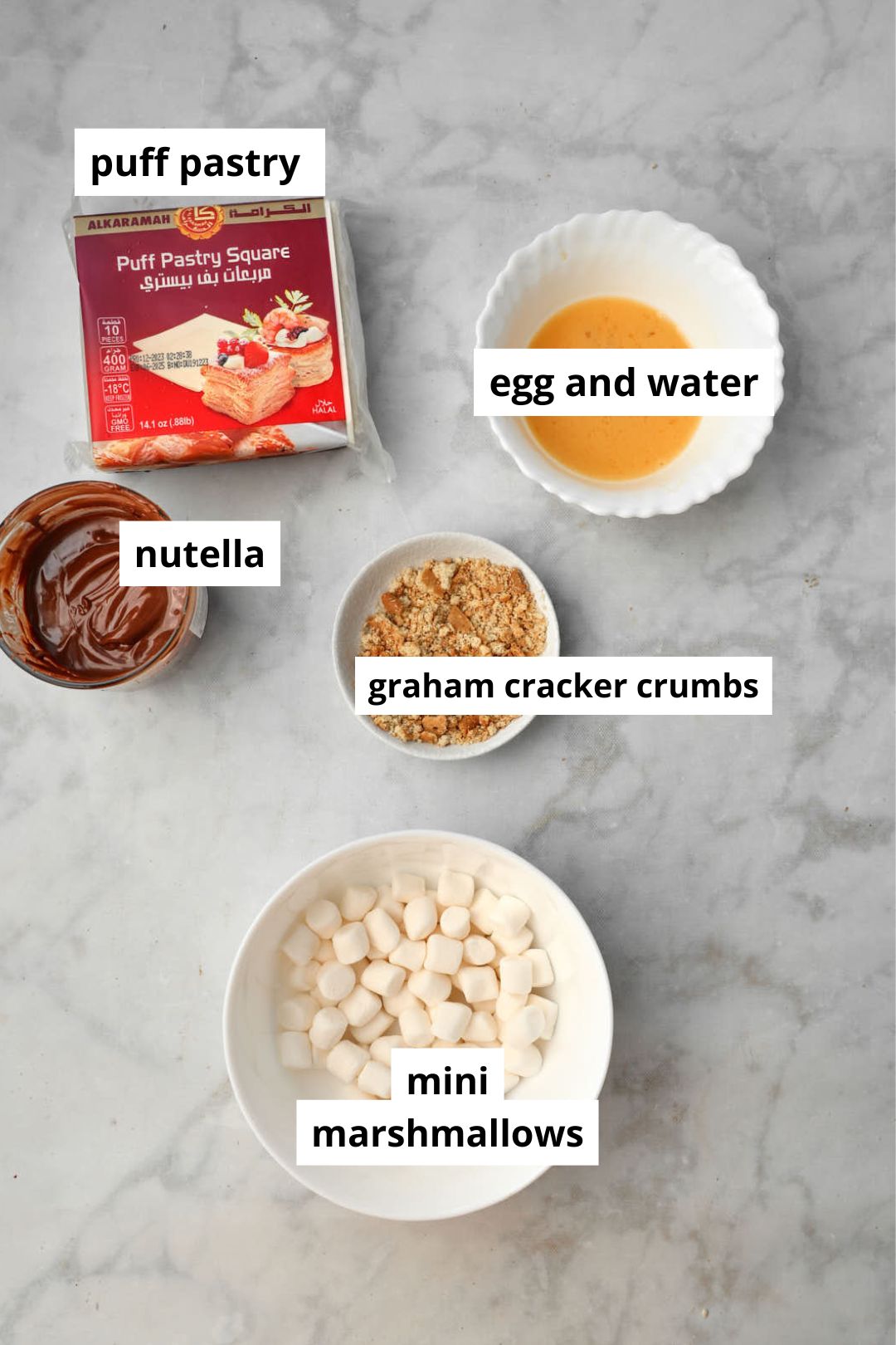 ingredients you need to make nutella marshmallwo turnovers on a white background.