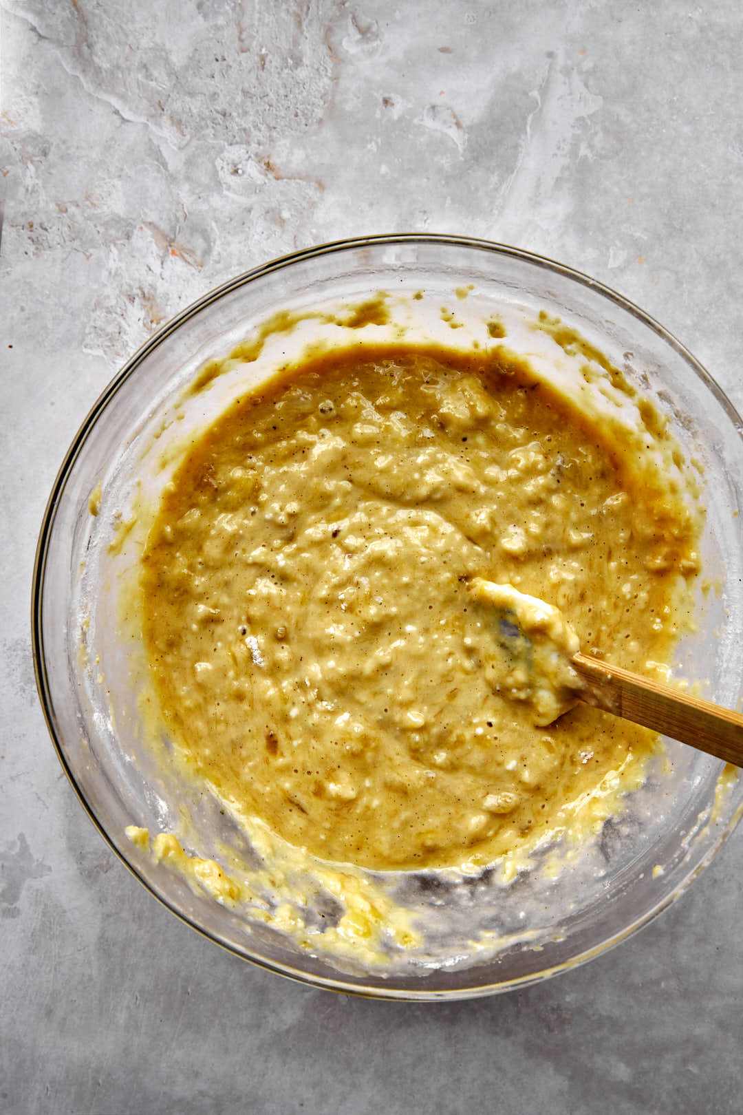 banana bread batter in a glass bowl.