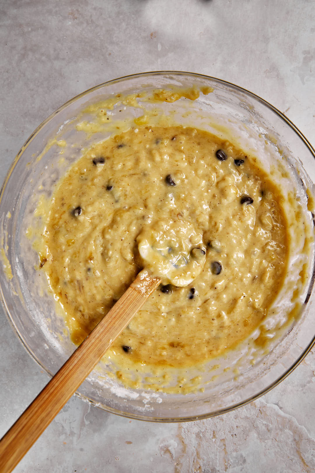 mixed chocolate chip banana bread batter in a glass bowl