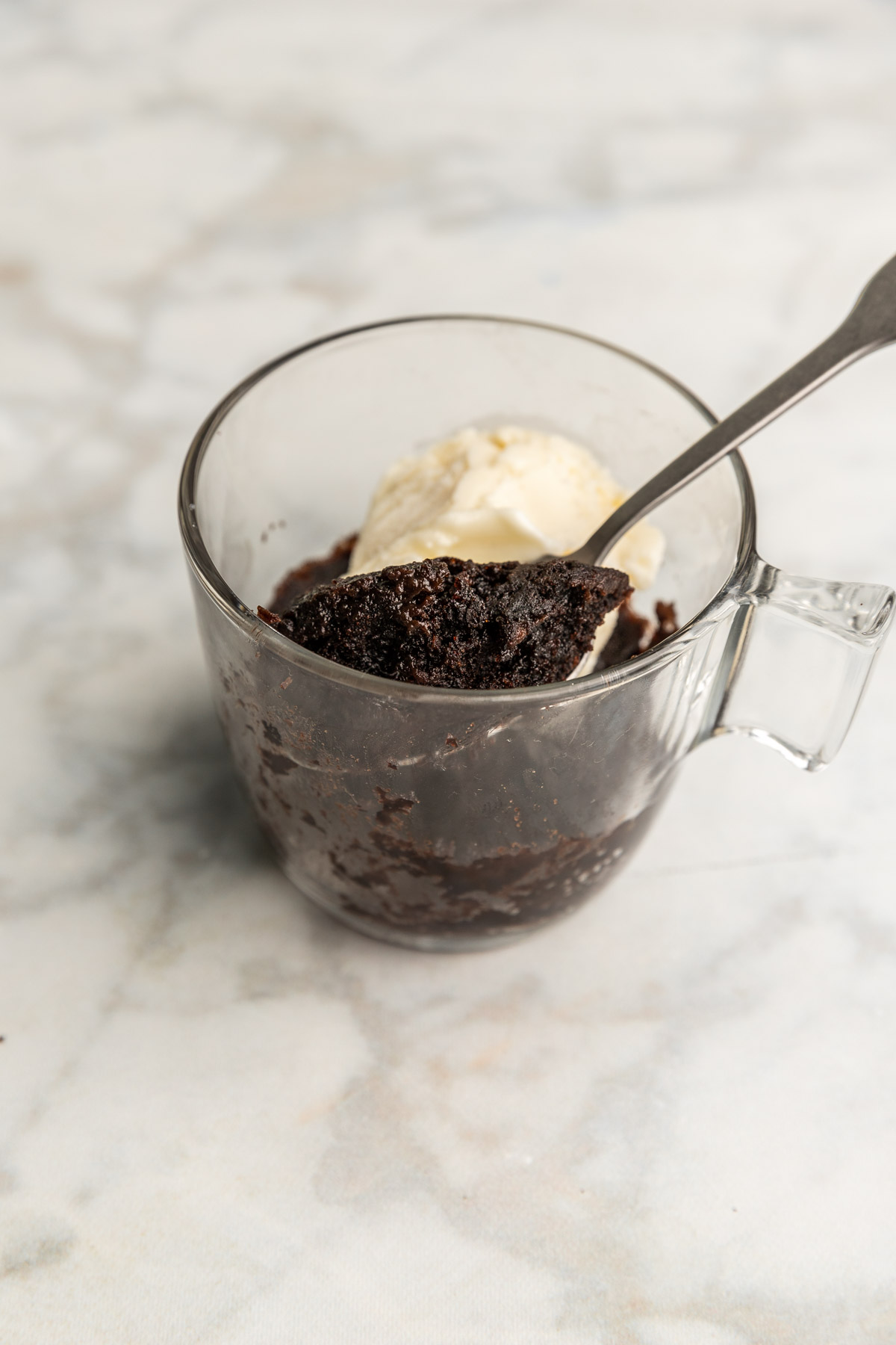 Spoon scooping out some Oreo microwave mug cake.
