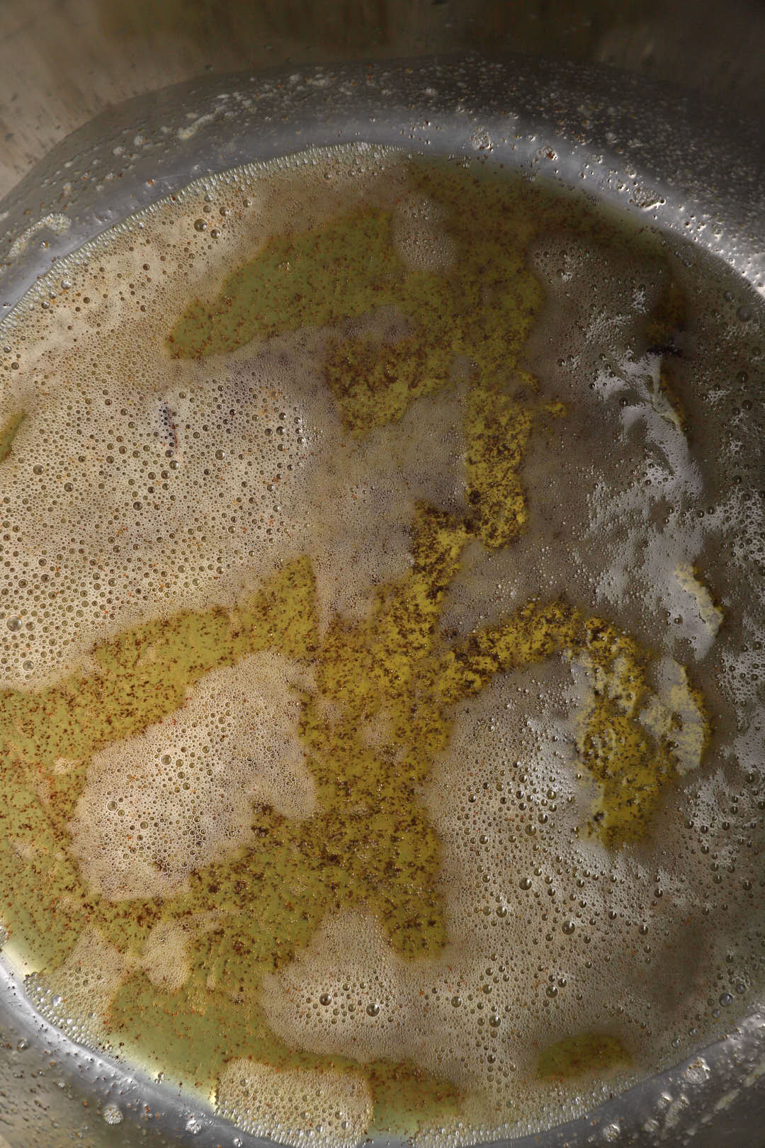 butter melted and foaming in a large silver pot.