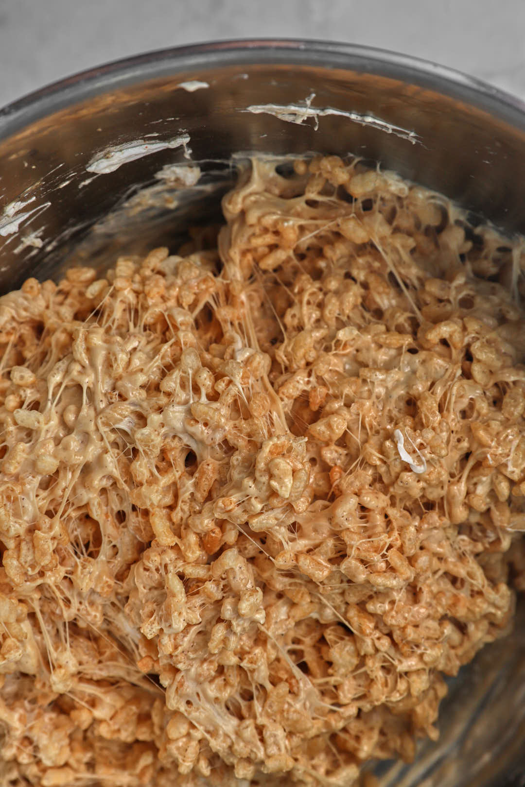 Rice Krispies mixed into the peanut butter marshmallow mixture in a pot.