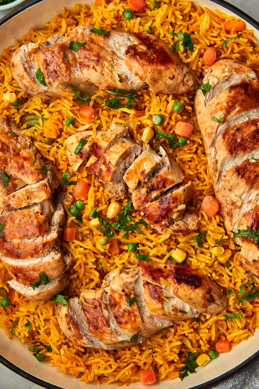 close up photo of chicken and rice in a large skillet.