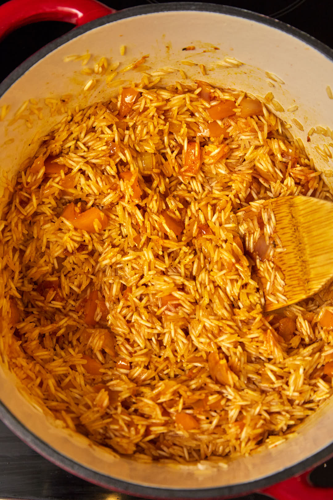 Basmati rice being toasted in a large skillet.