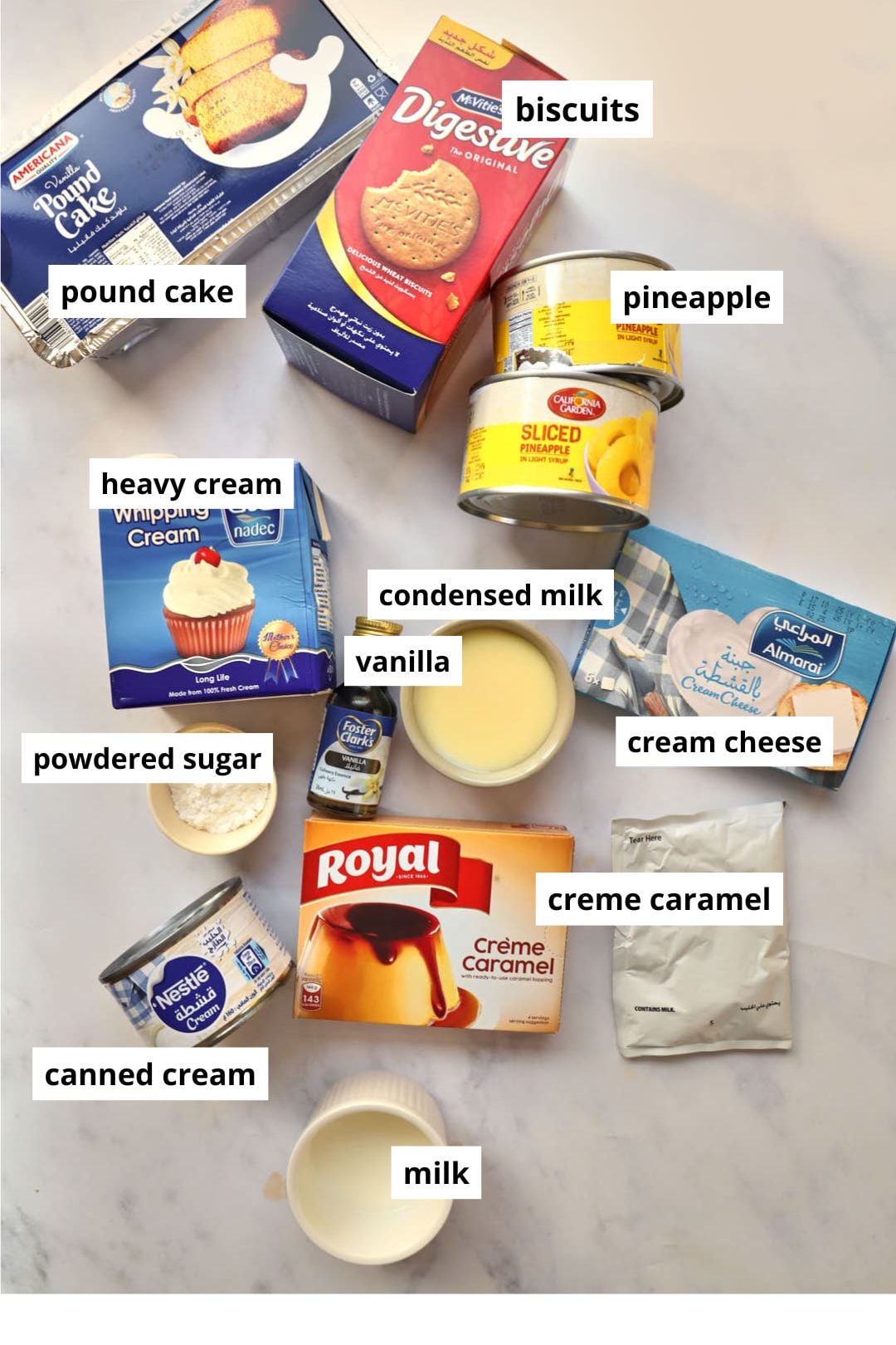 ingredients needed to make pineapple trifle on a marble background.