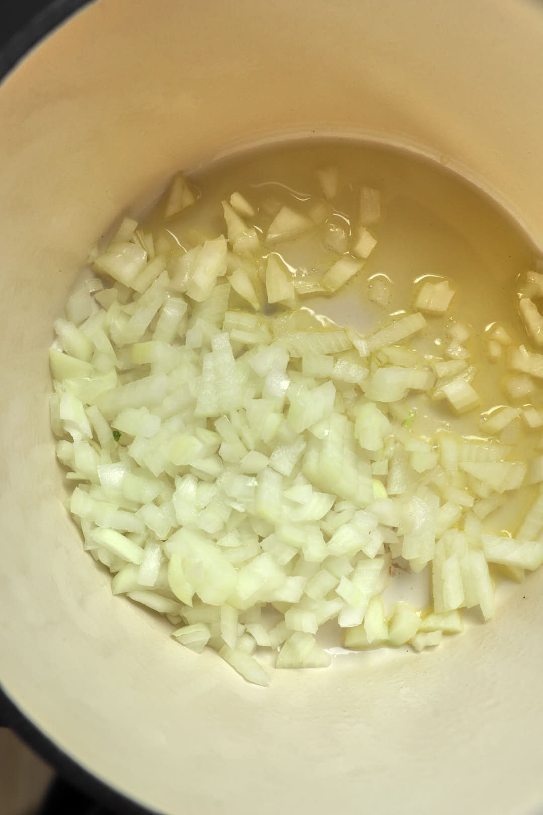 Onions sauteeing in a saucepan.