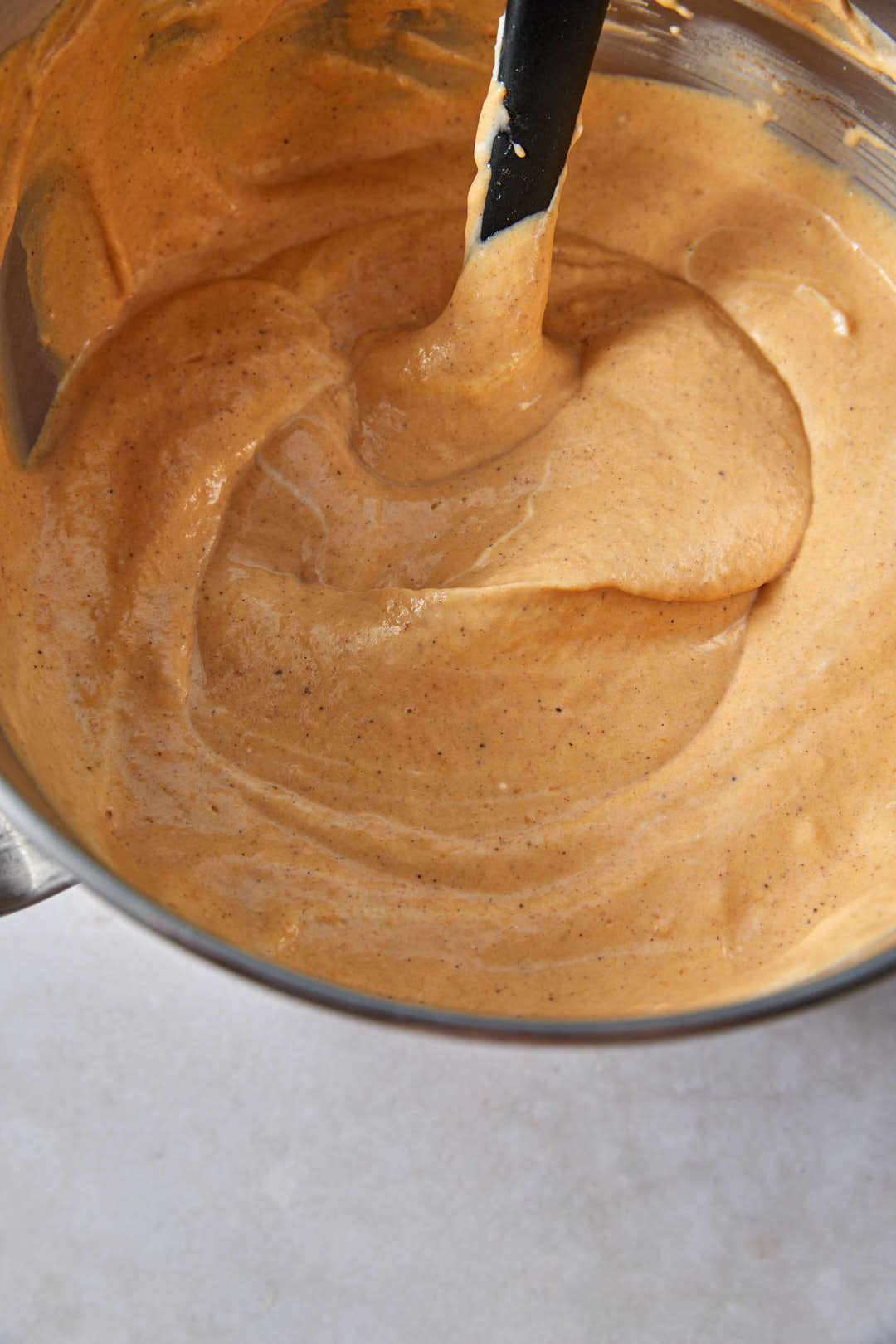 pumpkin cheesecake batter in stanx mider bowl.