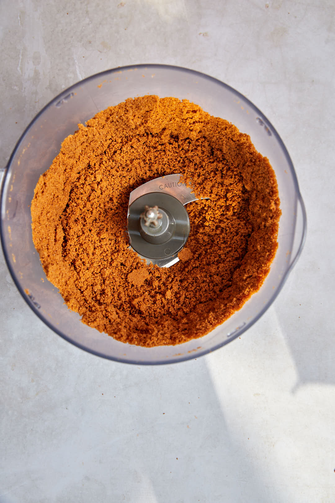 crushed biscoff biscuits in food processor.