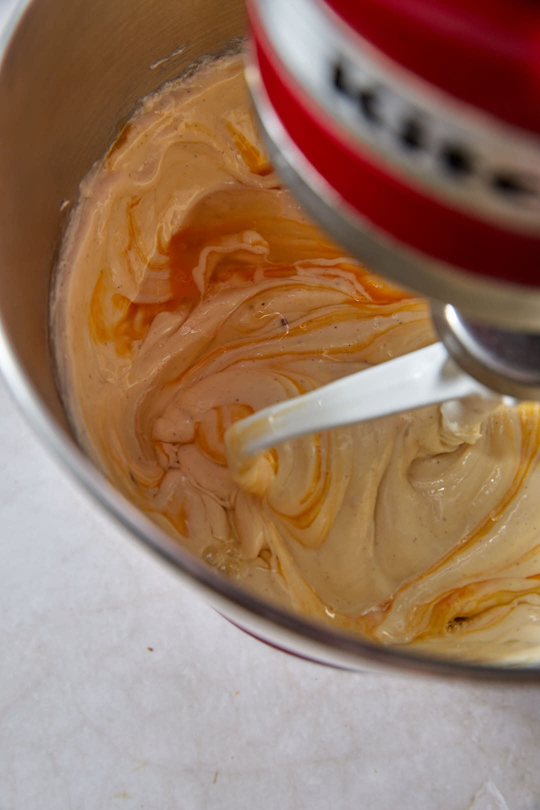 eggs added to cream cheese in mixer bowl.