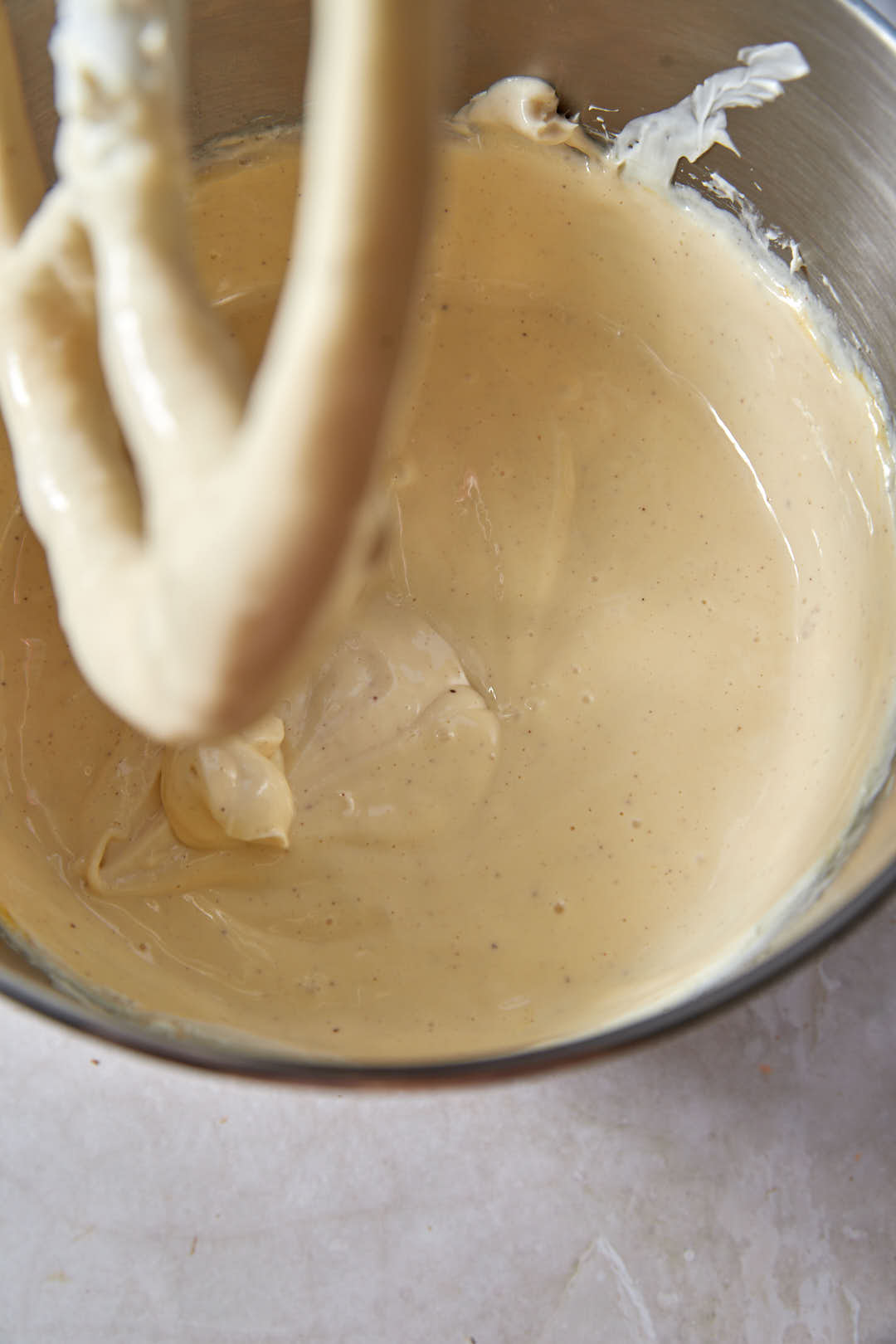 cheesecake batter in stand mixer with paddle attachment.