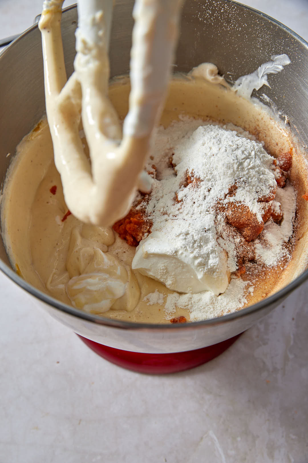 Pumpkin puree, flour and spices added to cream cheese in mixer bowl.