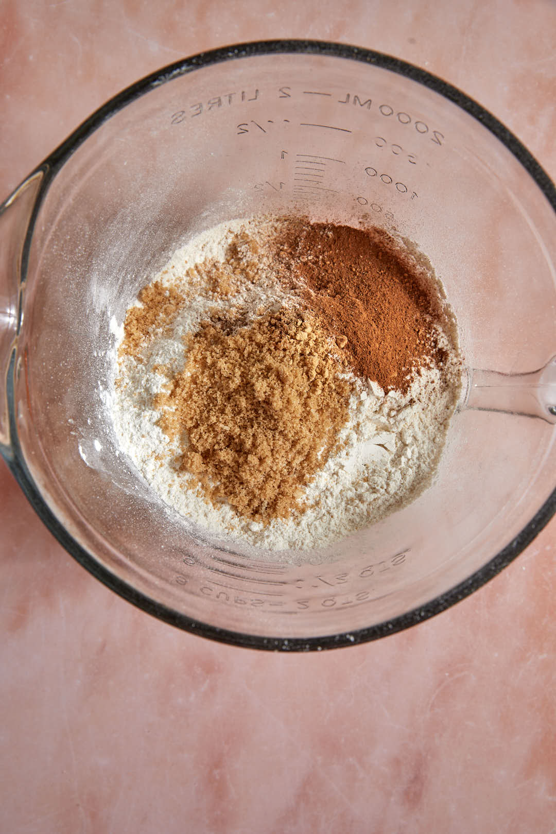 pancake mix, brown sugar, cinnamon and spices in a clear glass bowl.