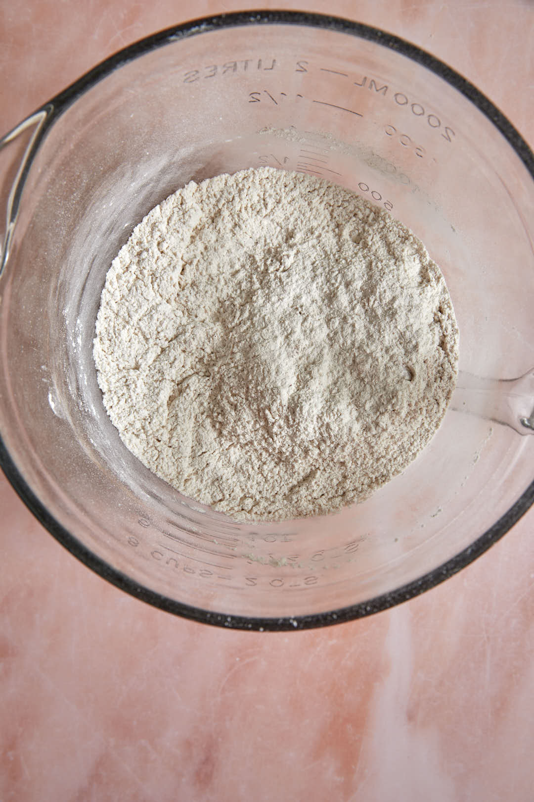 whisked dry ingredients for pancakes in a glass bowl.