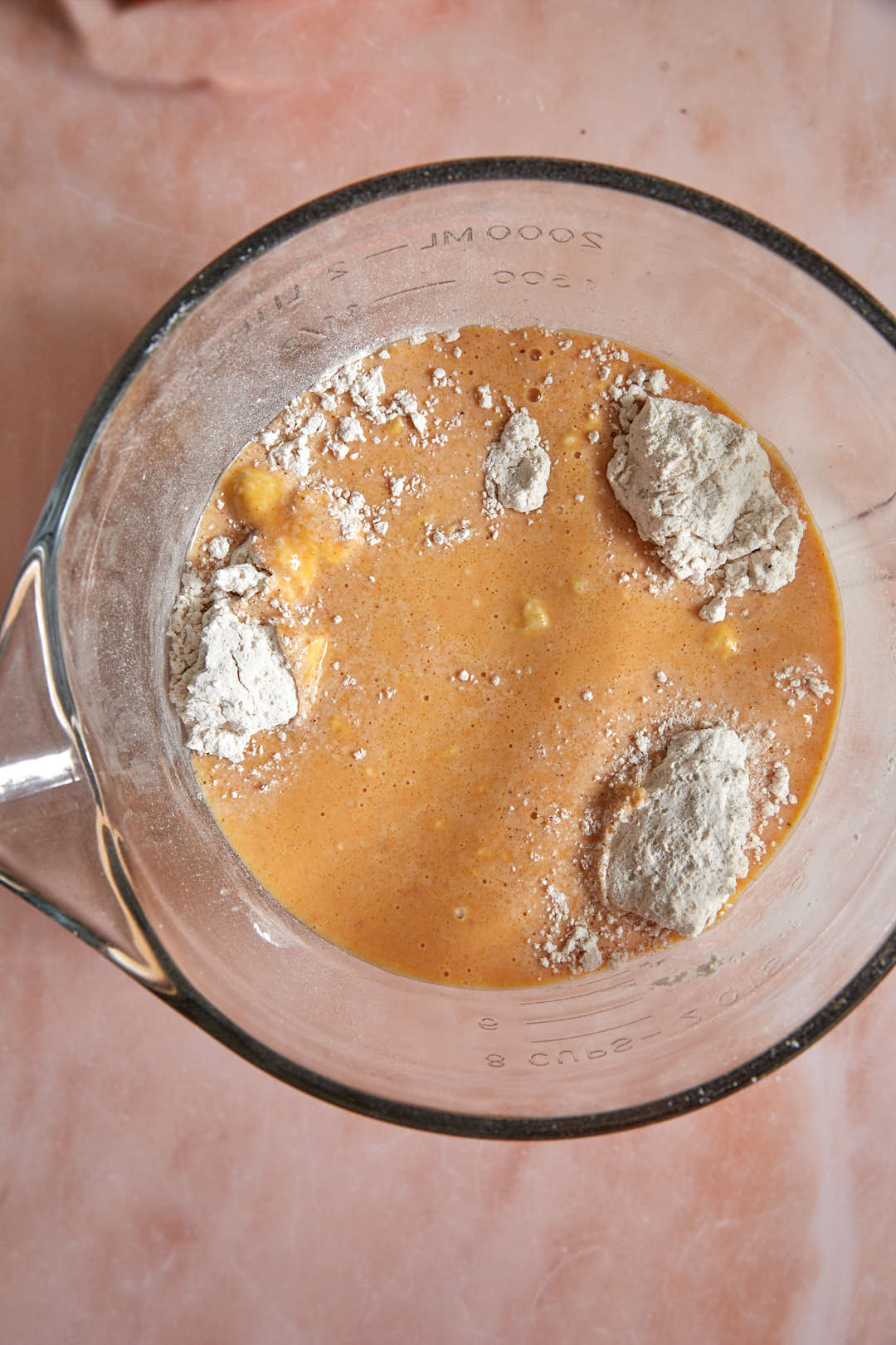 Dry ingredients and wet pumpkin pancake batter ingredients together in a bowl.