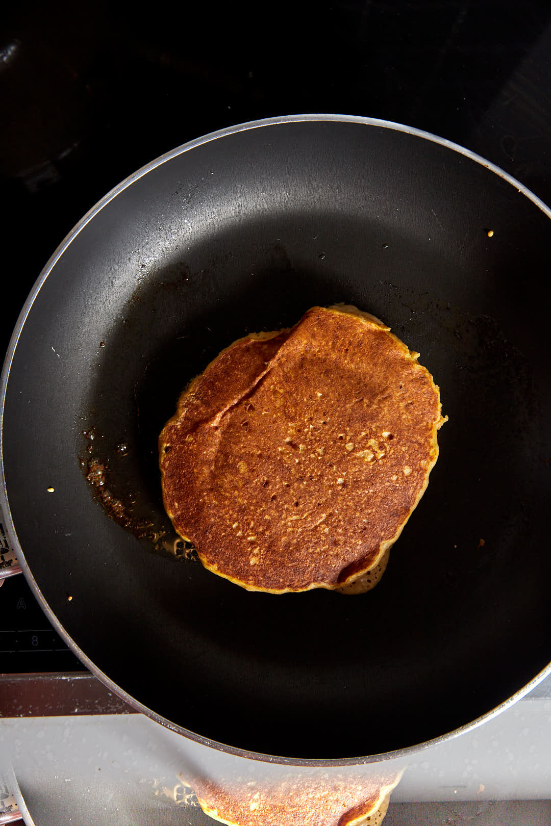 Cooked pumpkin pancake in a skillet.