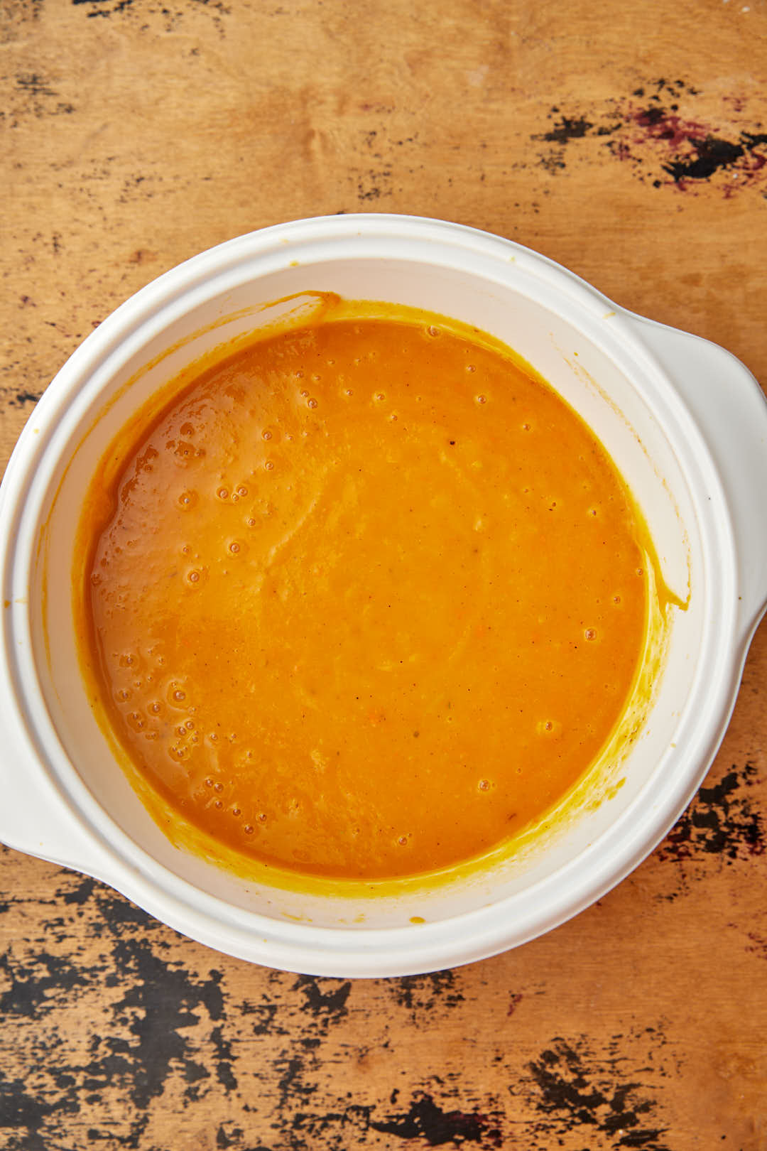 blended roasted butternut squash and carrot soup in white saucepan