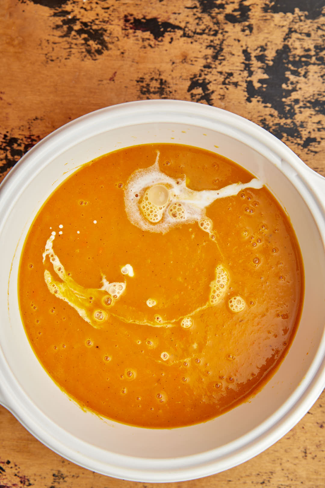coconut milk being added to butternut squash soup