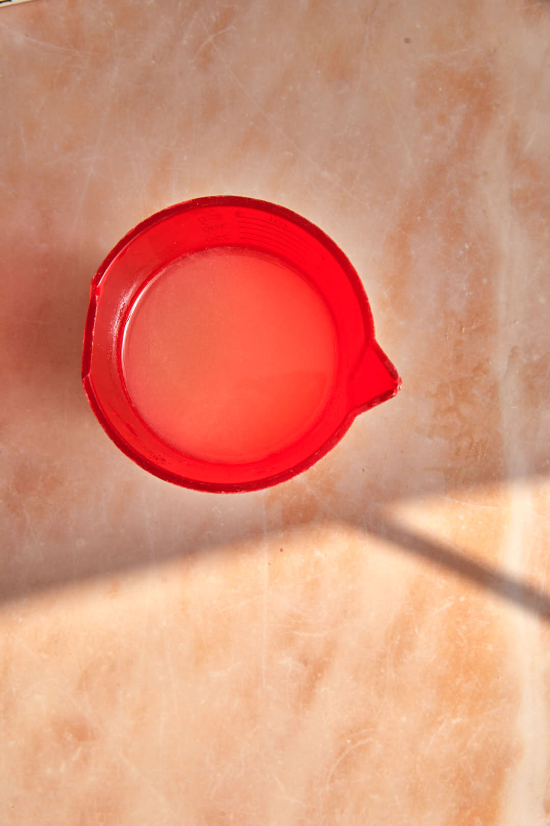 lemon juice in a red measuring cup.