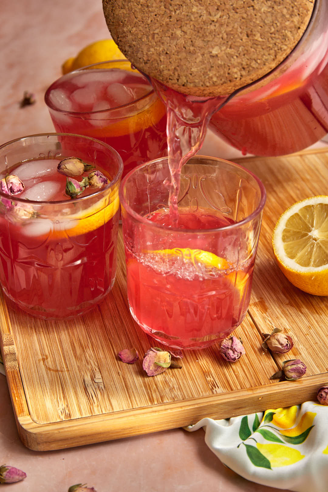 Rose lemonade being poured out into a glass.
