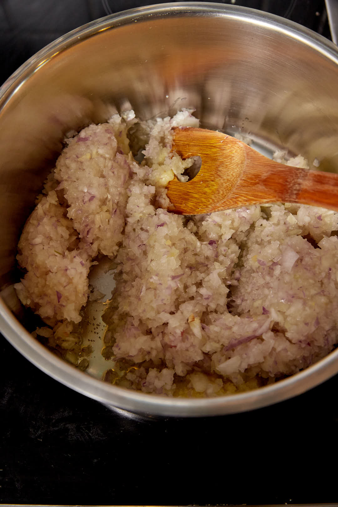 Grated onions added to a large hot pot.