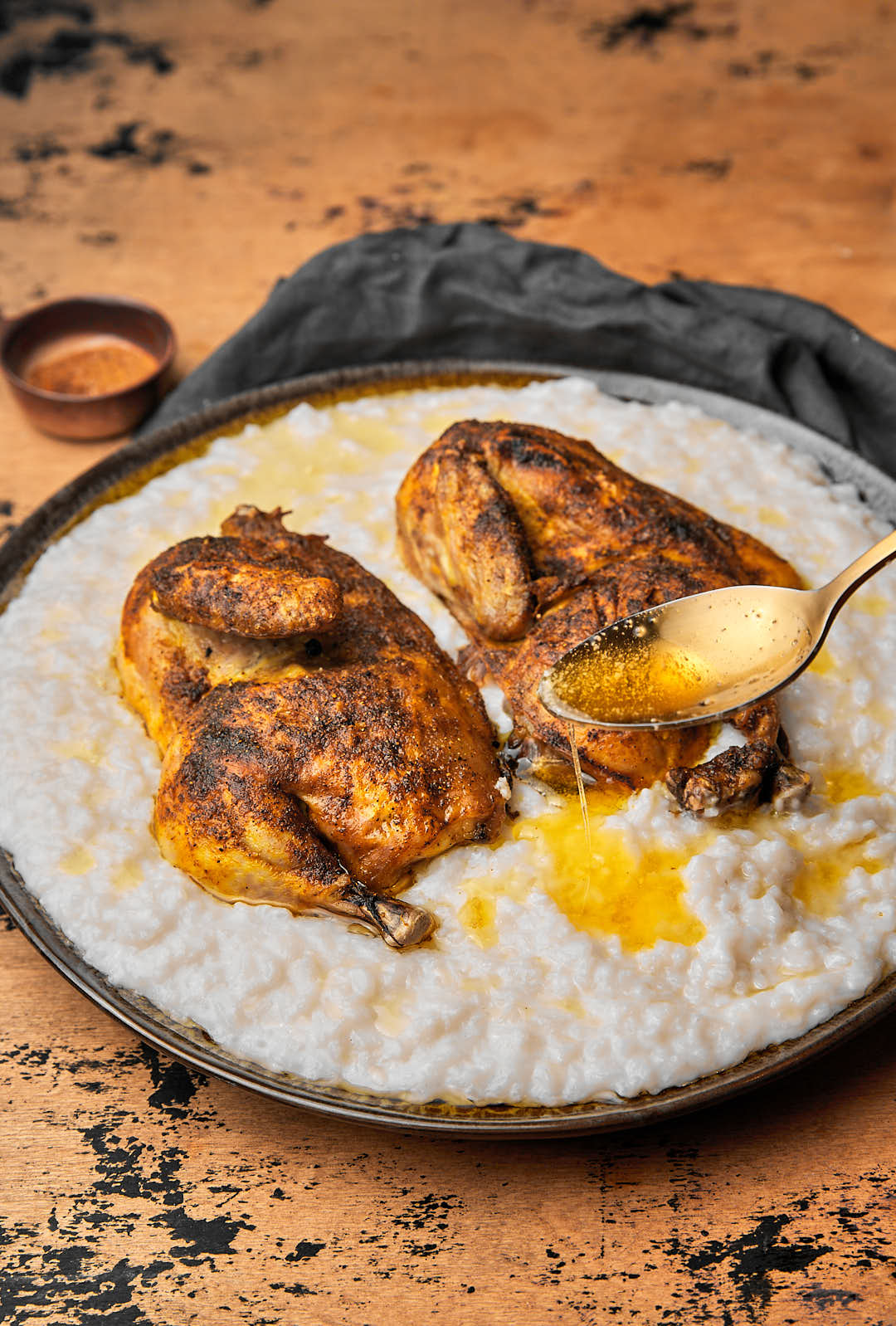 ghee being spooned onto chicken and rice saleeg.