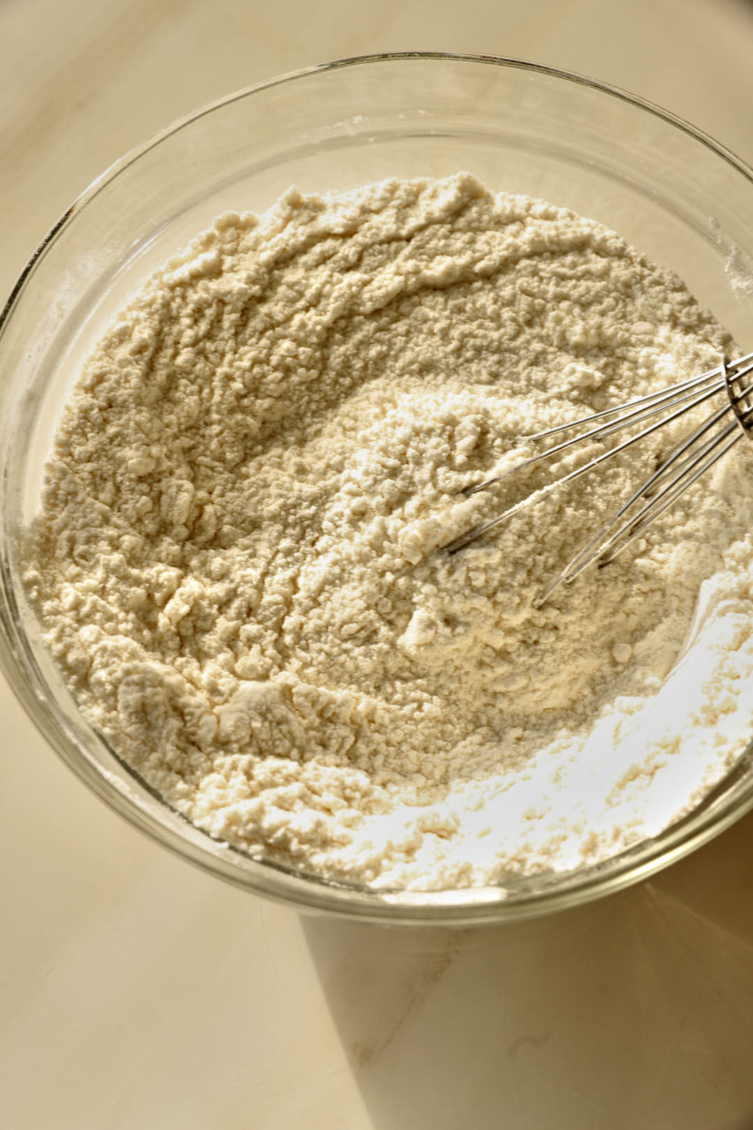 flour, baking soda, and salt mixed together in a glass bowl.