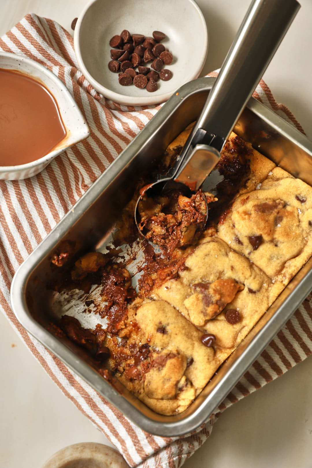 A pan of scoopable cookies with an ice cream scoop coming out.