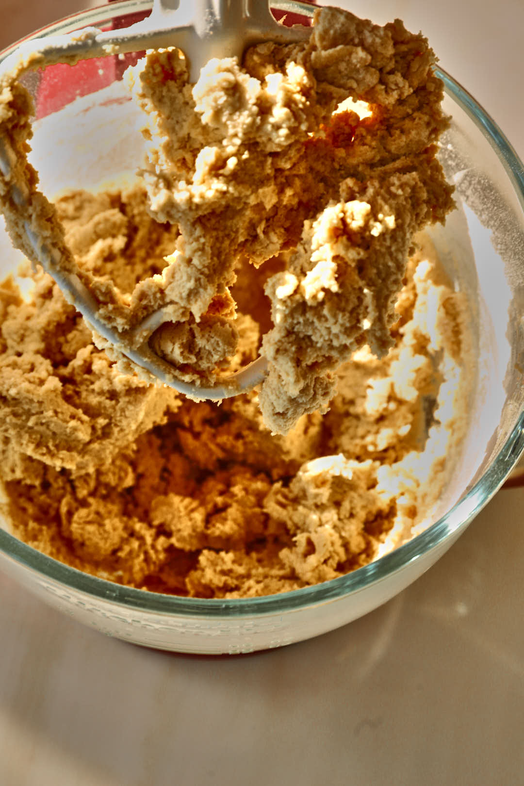 cookie dough in glass stand mixer bowl.