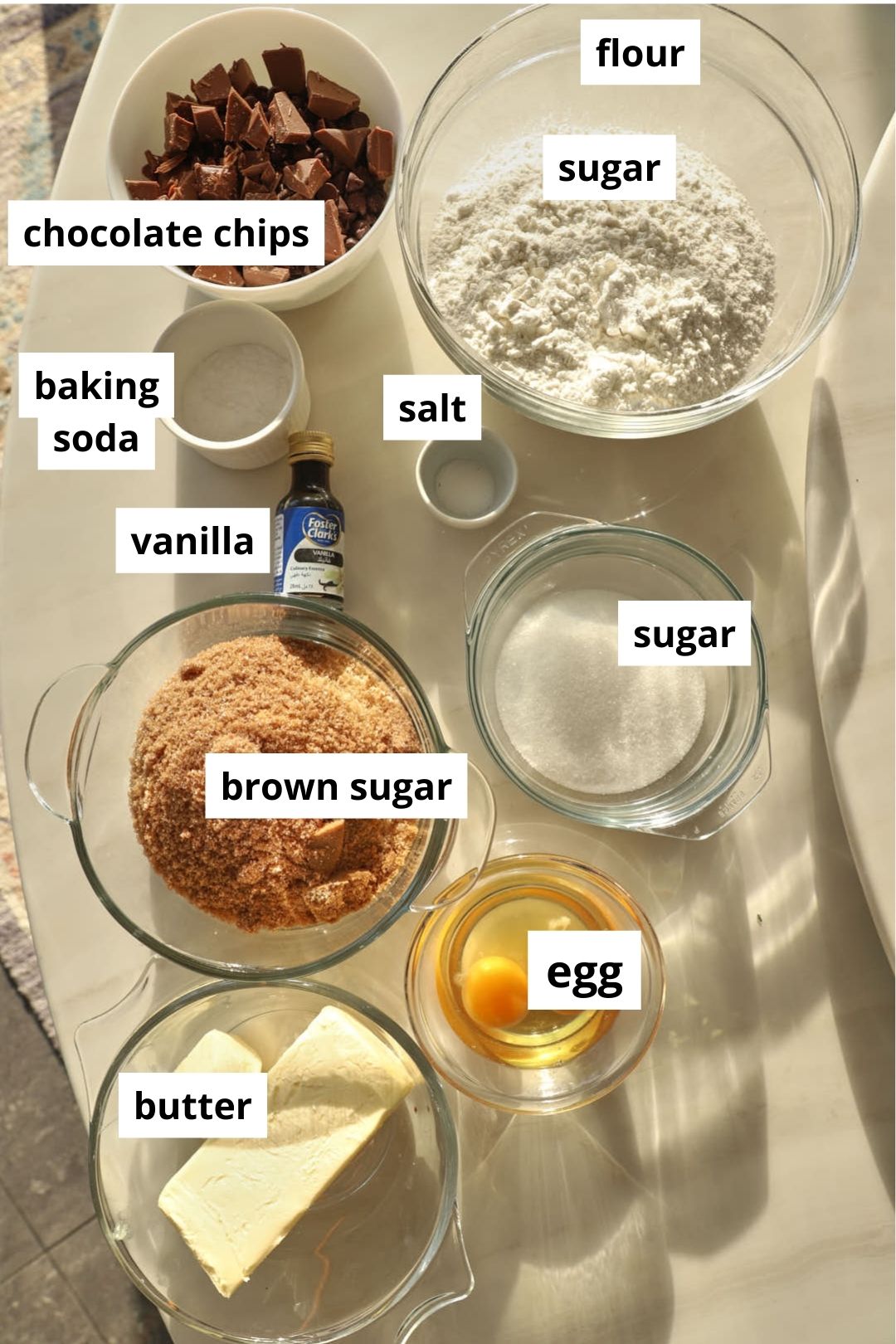 ingredients you need to make scoopable cookies on a white marble table