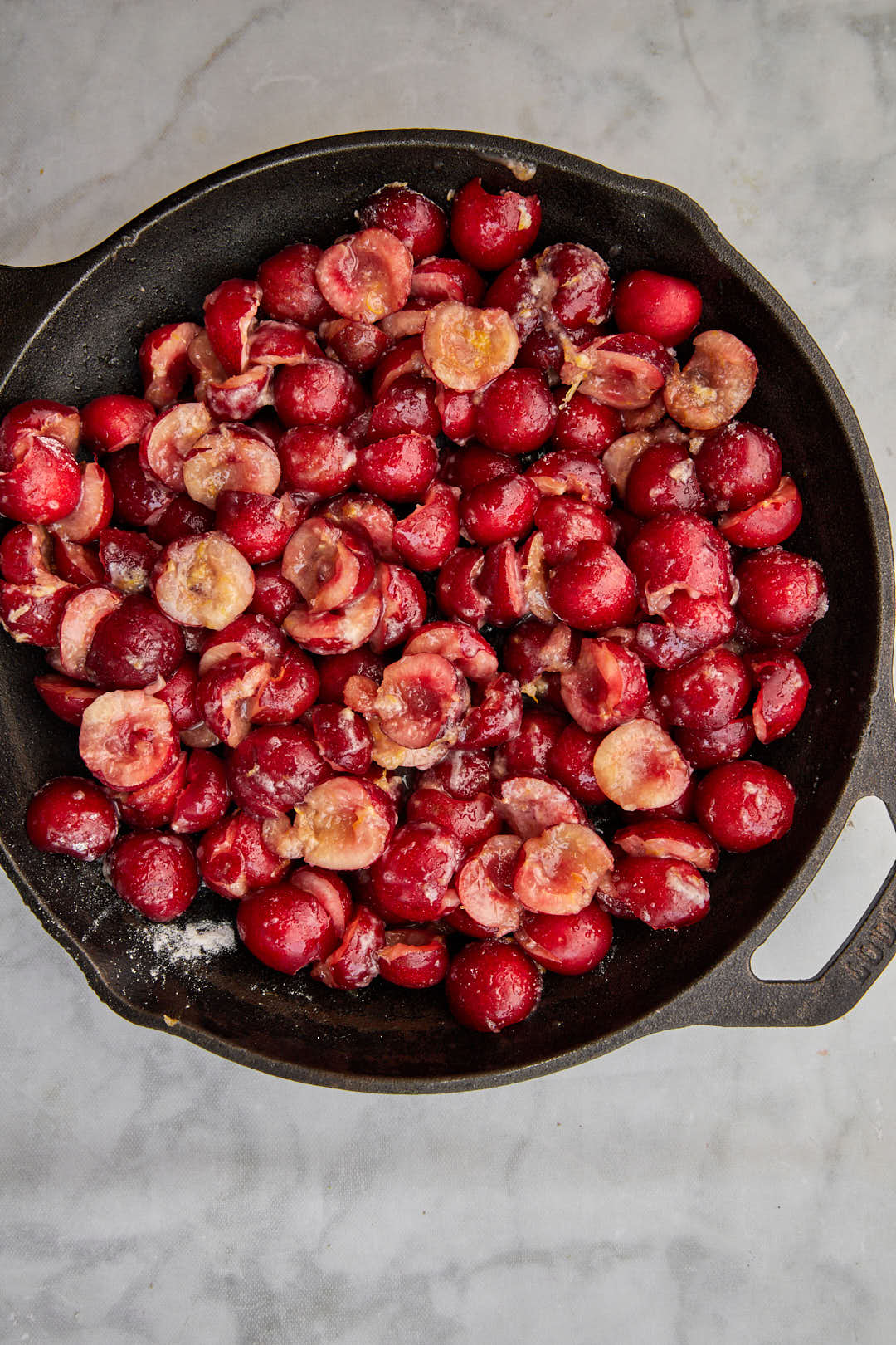 cherry cobbler filling in cast iron skillet.