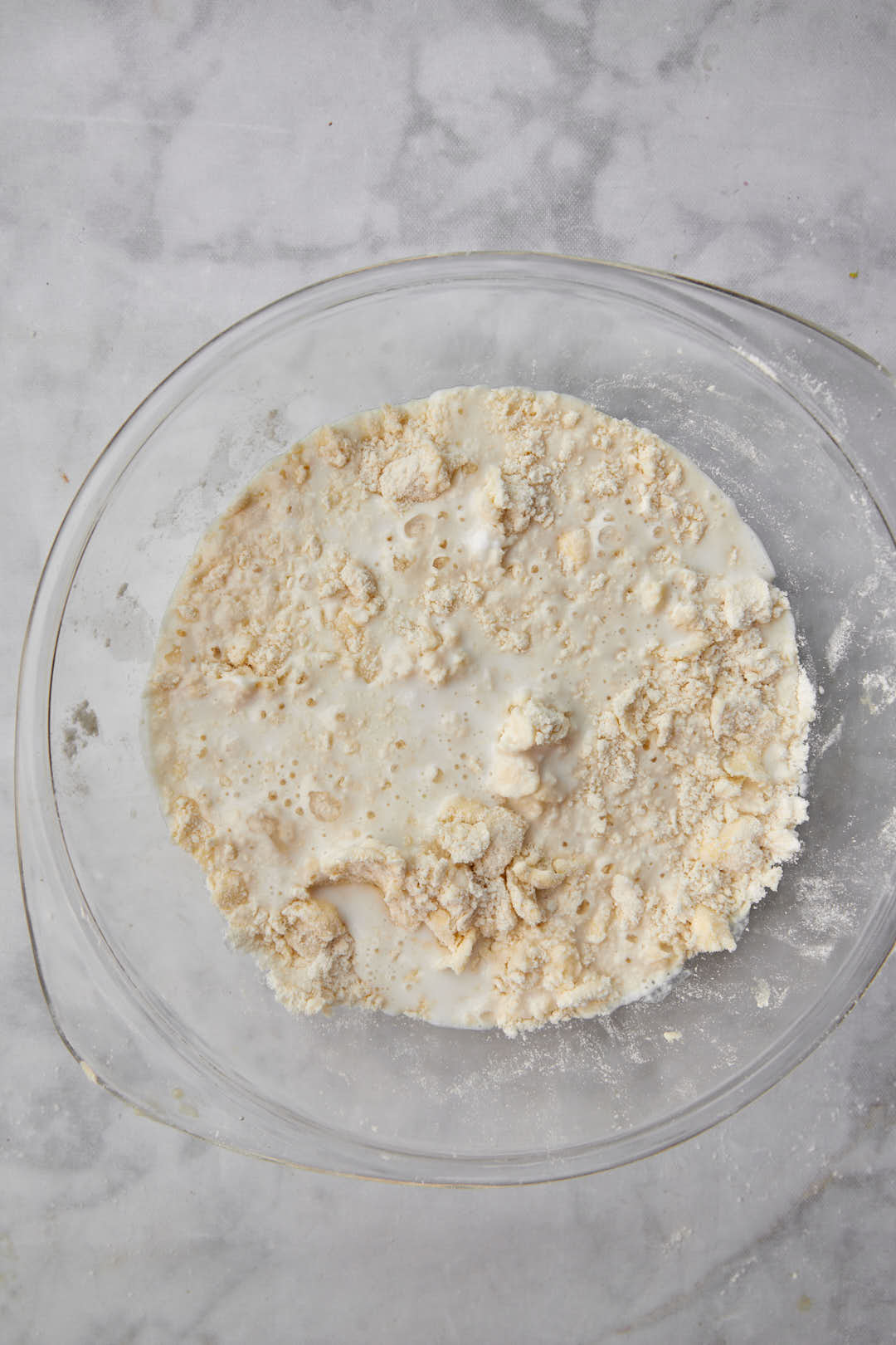 Buttermilk added to a futter and flour mixture in a glass bowl