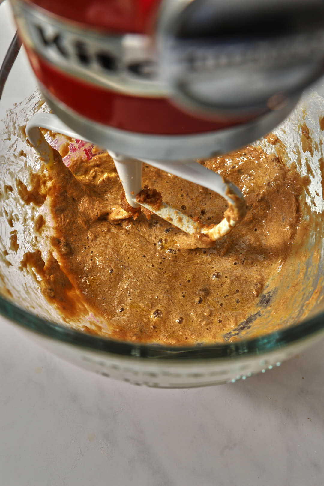 creamed butter and sugar in a glass bowl of a stand mixer.