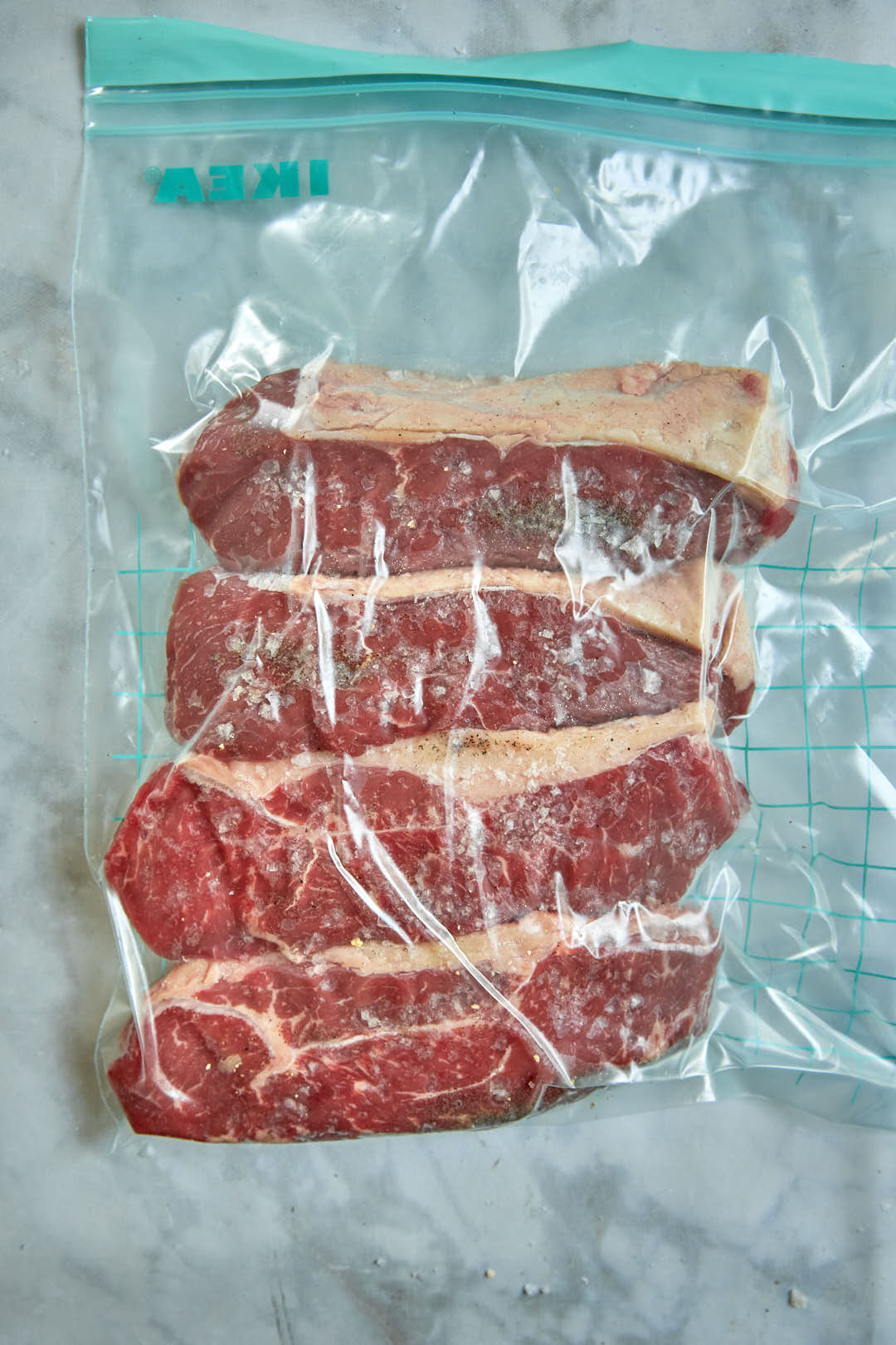 vacuum sealed sirloin steaks in plastic bag.