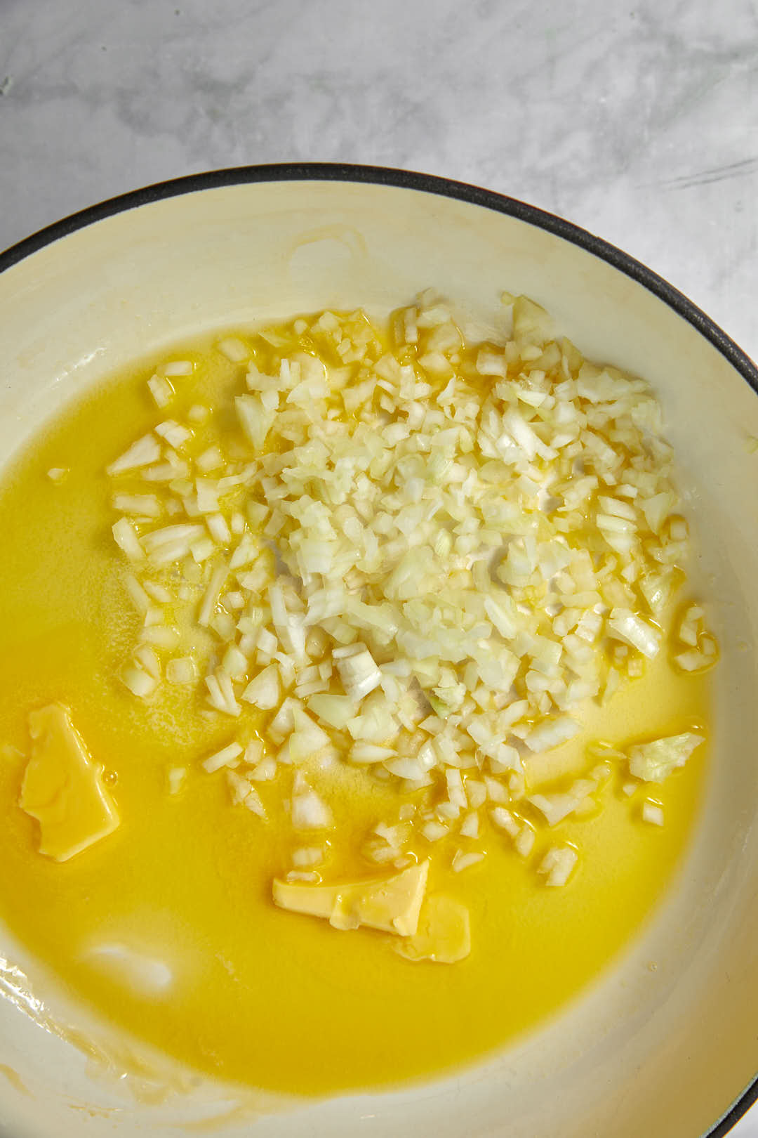 diced onion added to olive oil and butter in a large skillet.