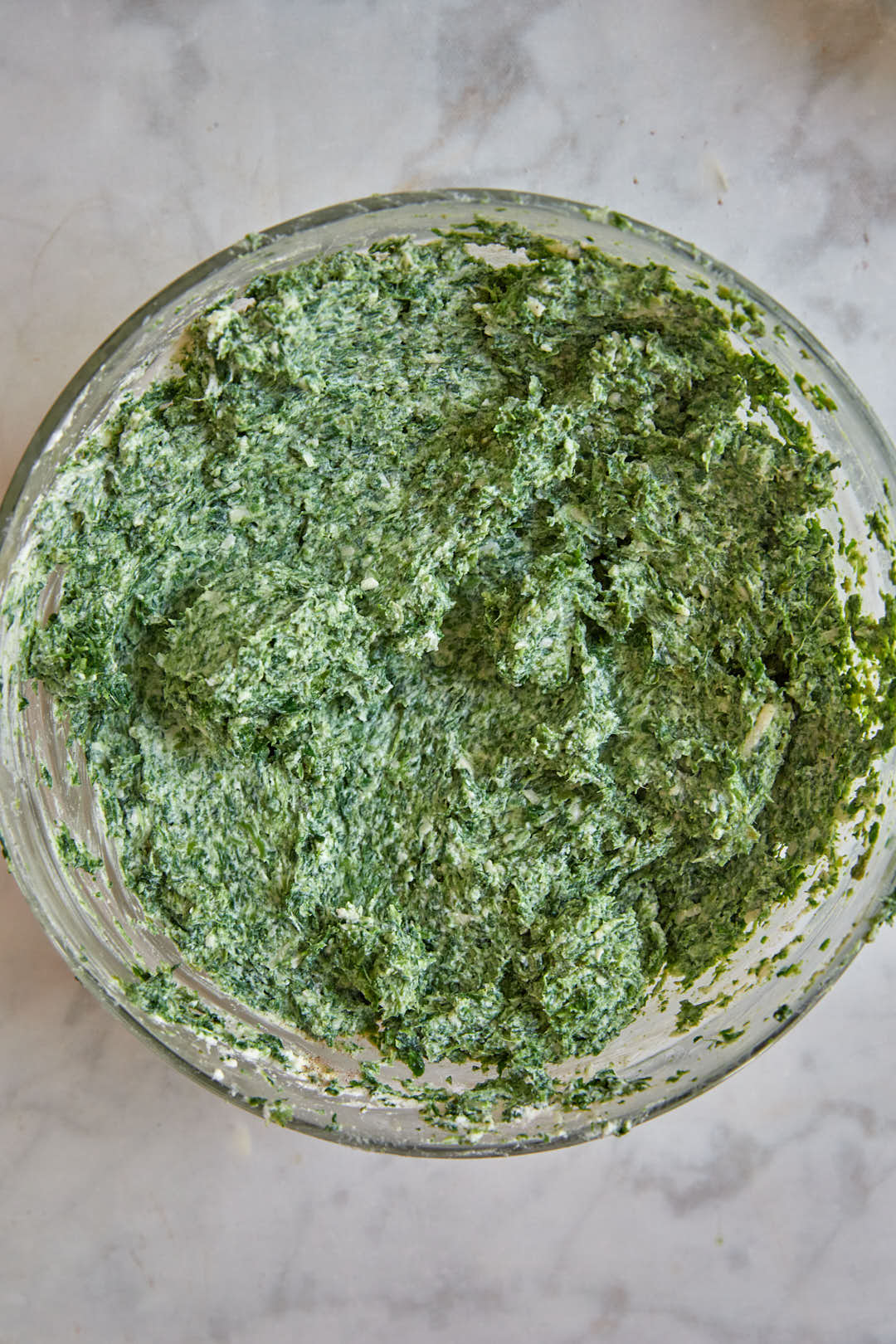 Spinach parmesan and ricotta filling in a glass bowl.