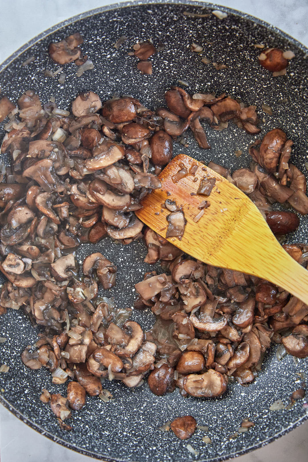 cooked sliced brown mushrooms in a large skillet.
