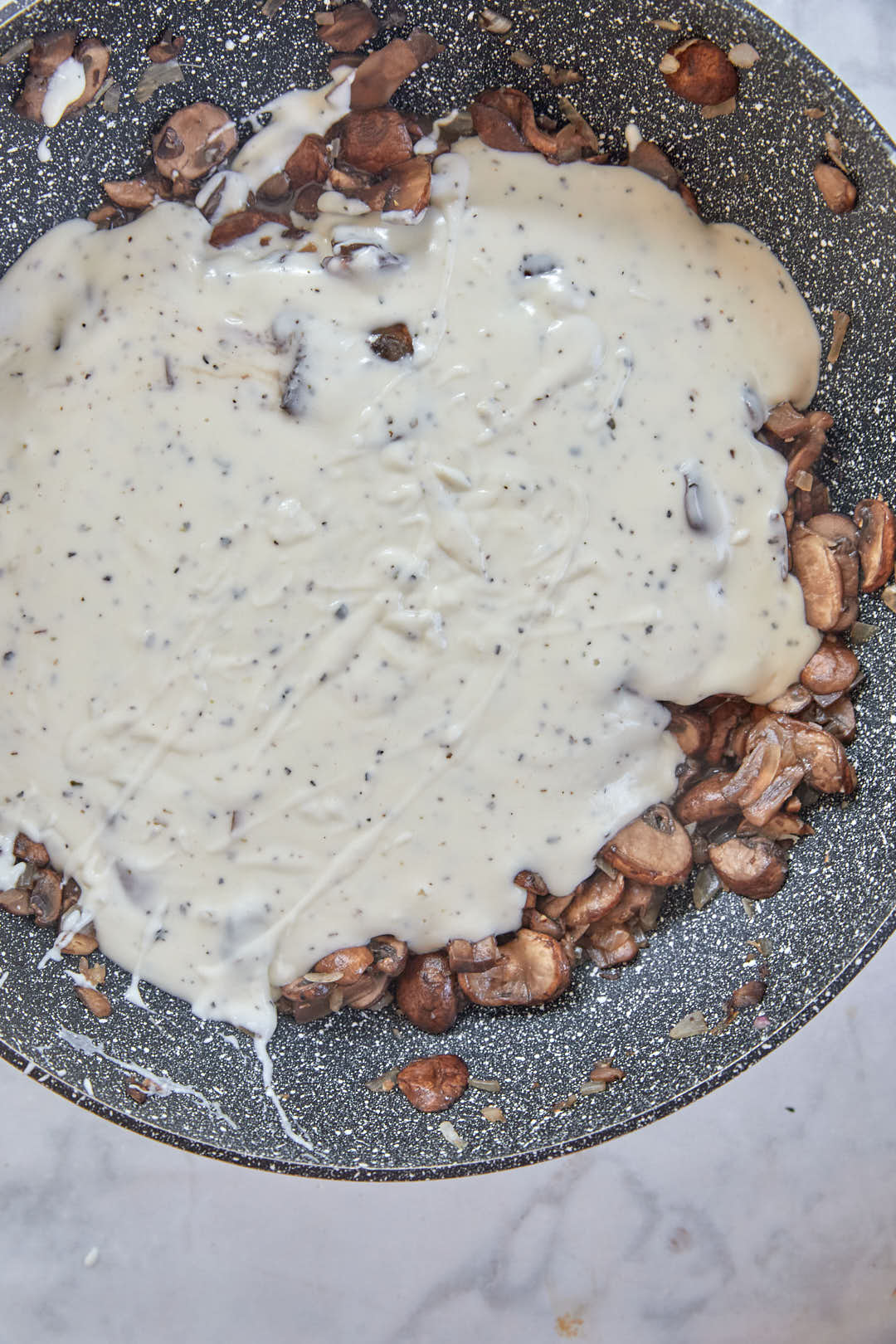 sliced mushrooms added to bechamel sauce.