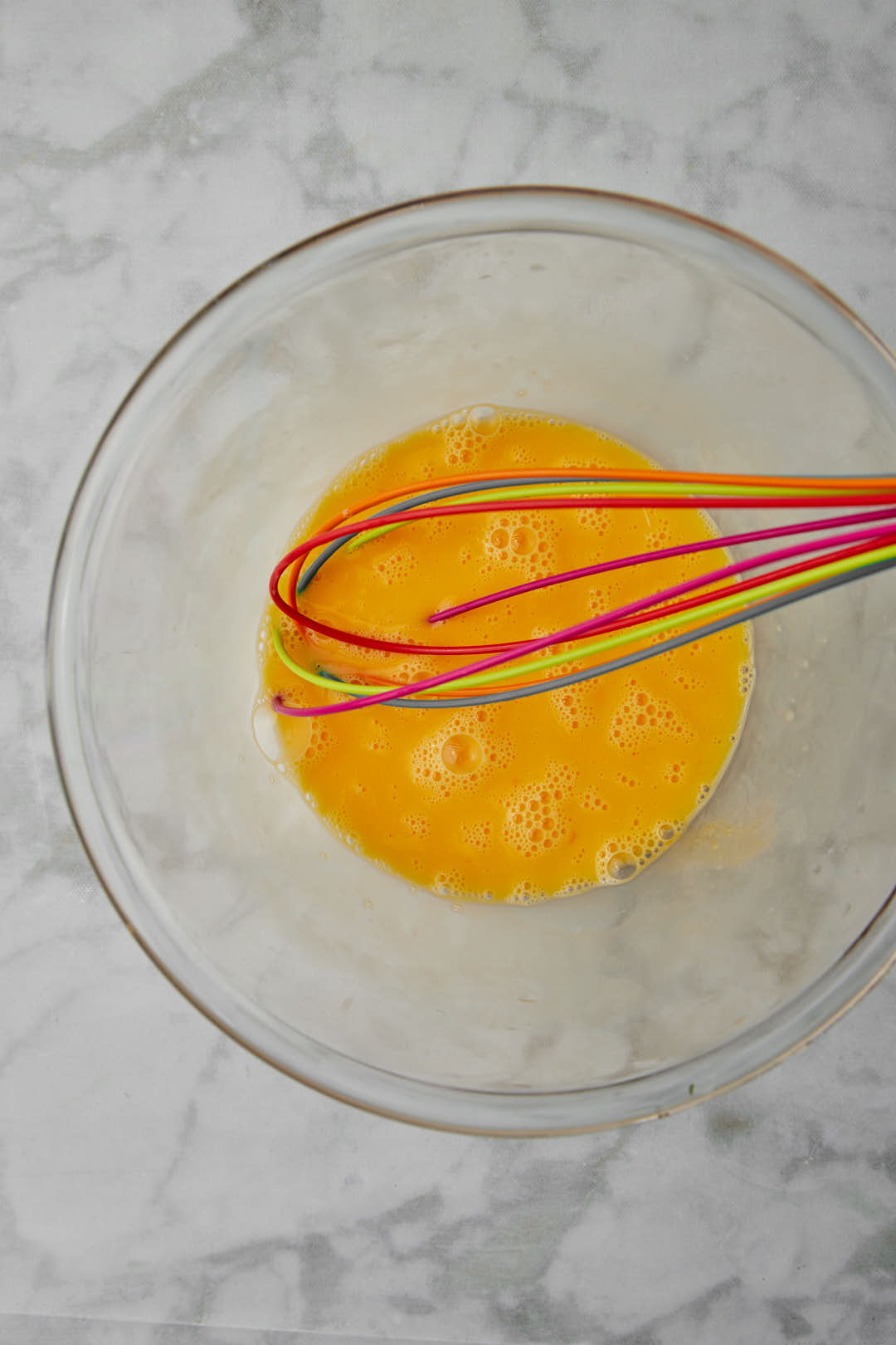 beaten eggs in a clear bowl.