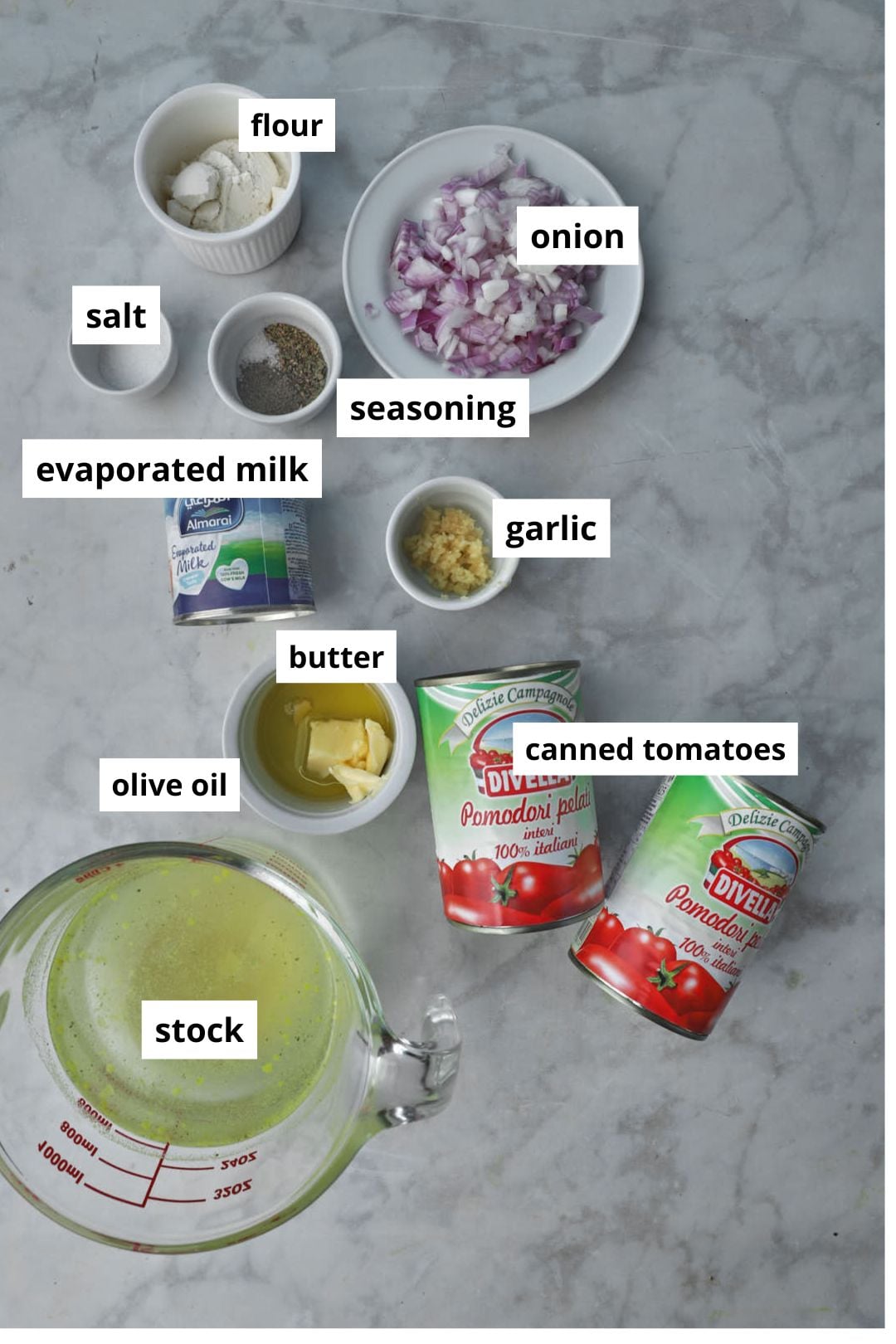 canned tomato soup ingredients on a white background.
